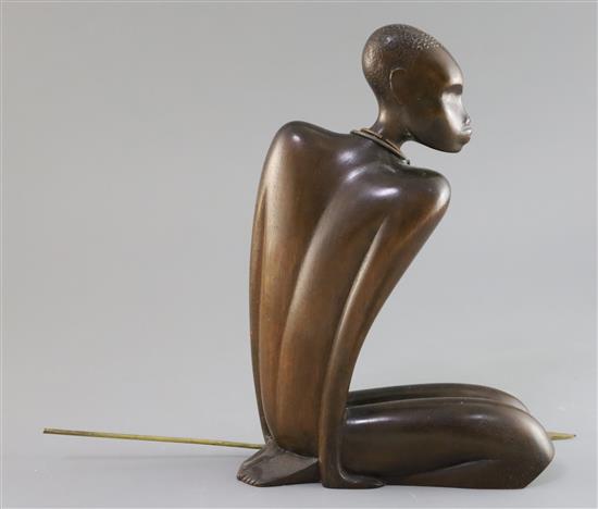 A Hagenauer hardwood figure of a kneeling native man holding a brass spear, height 10.5in.